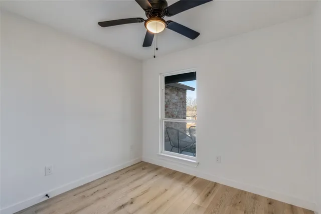 an empty room with closet and chandelier fan