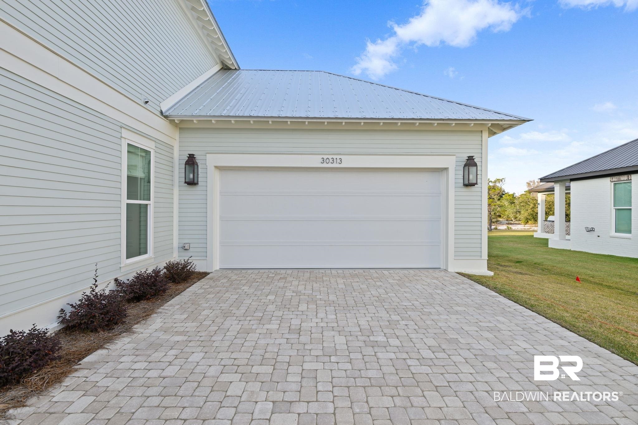 30313 River Road Orange Beach, AL 36561 - Photo 7 of 50 Garage featuring decorative driveway