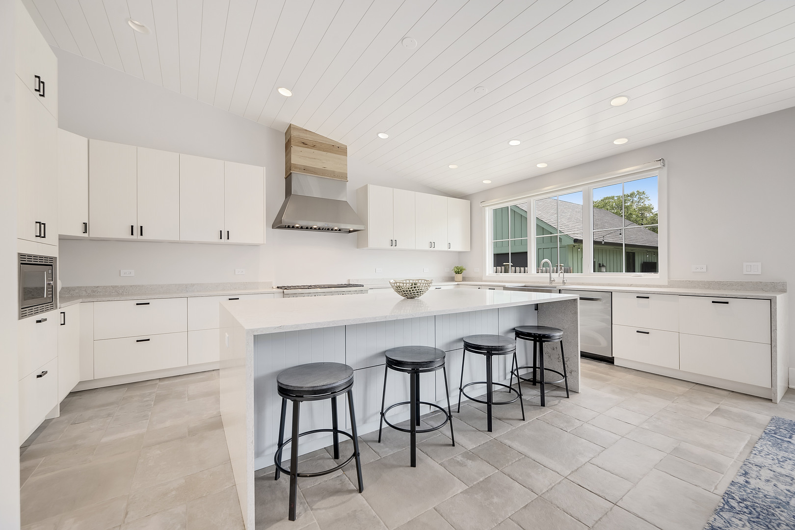 4333 Roslyn Road Downers Grove, IL 60515 - Photo 11 of 67 a kitchen with white cabinets and chairs