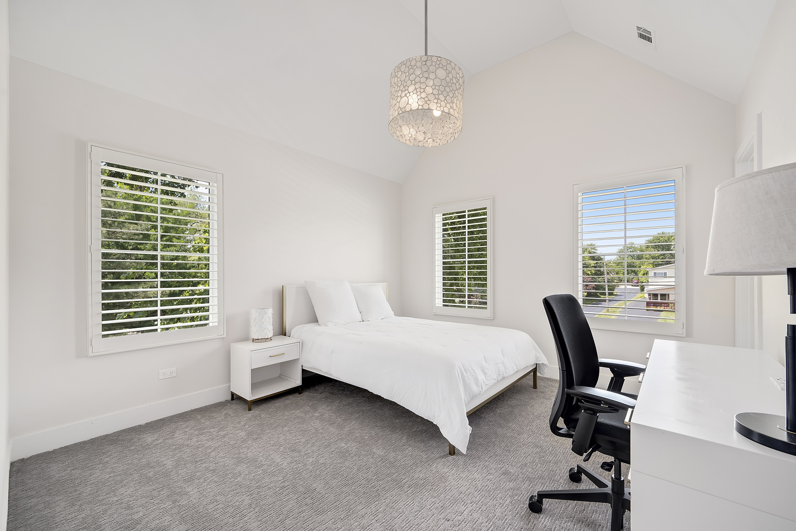 4333 Roslyn Road Downers Grove, IL 60515 - Photo 35 of 67 a bedroom with a bed a large window and a chandelier