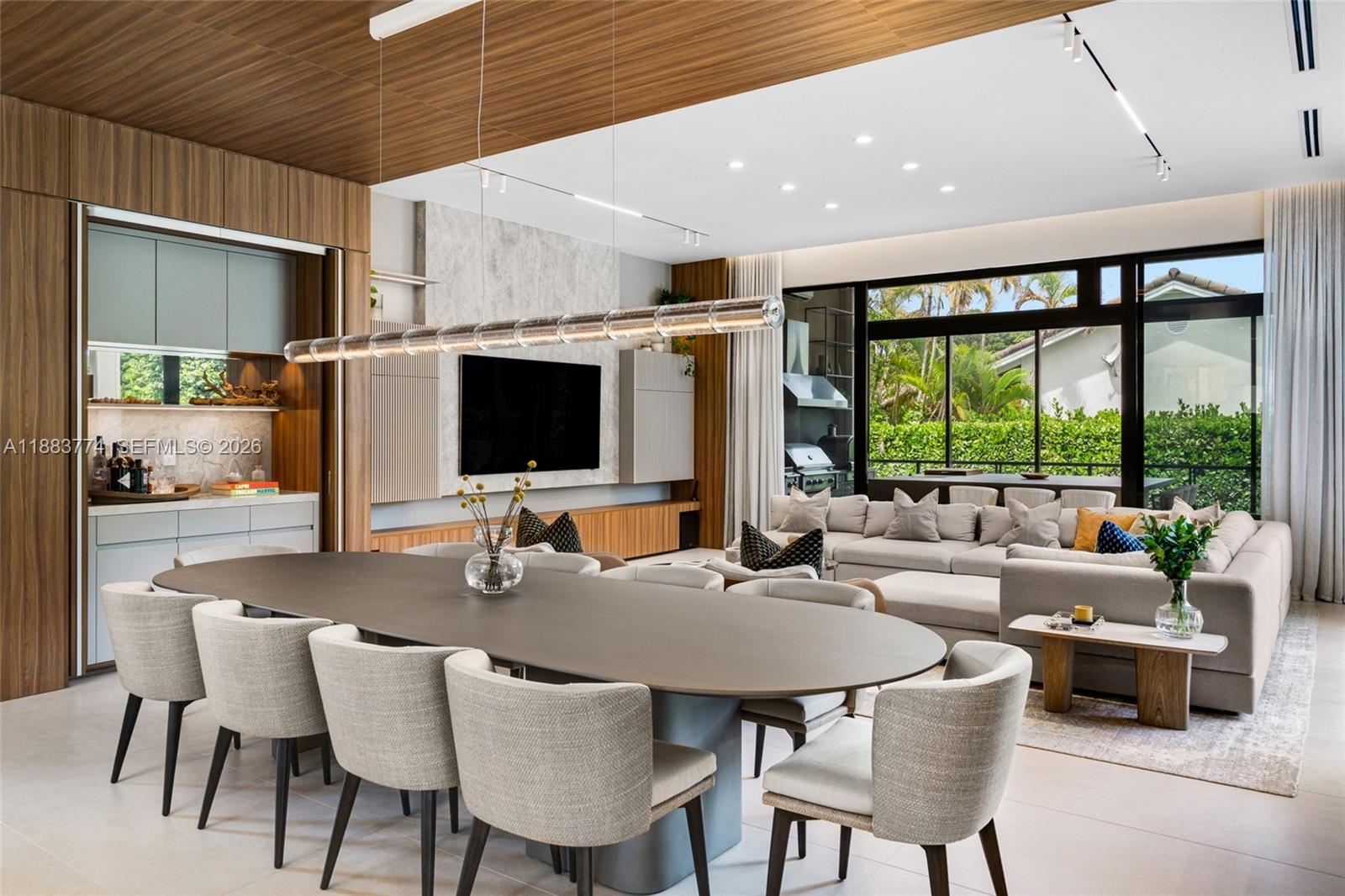 13120 Old Cutler Road Pinecrest, FL 33156 - Photo 12 of 56 a dining room with furniture a large window and a projector
