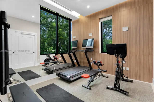 a living room with furniture a large window and a fireplace