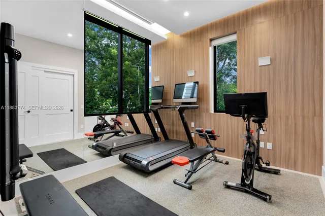 a living room with furniture a large window and a fireplace
