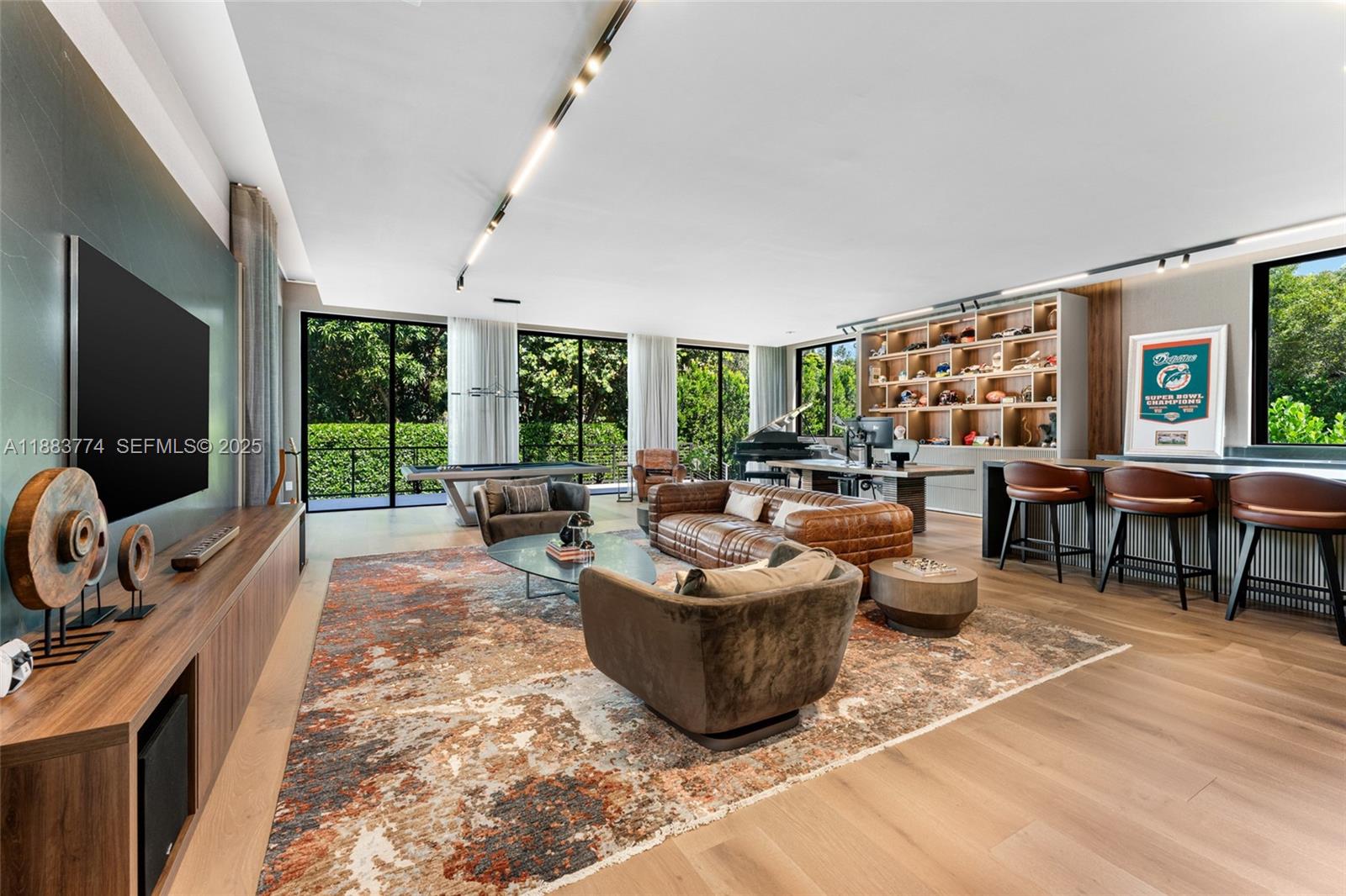 13120 Old Cutler Road Pinecrest, FL 33156 - Photo 19 of 58 a living room with furniture and a flat screen tv