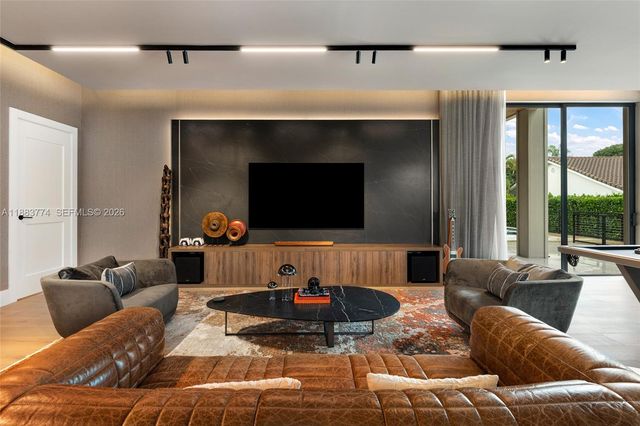 a hallway with a couch and a view of living room