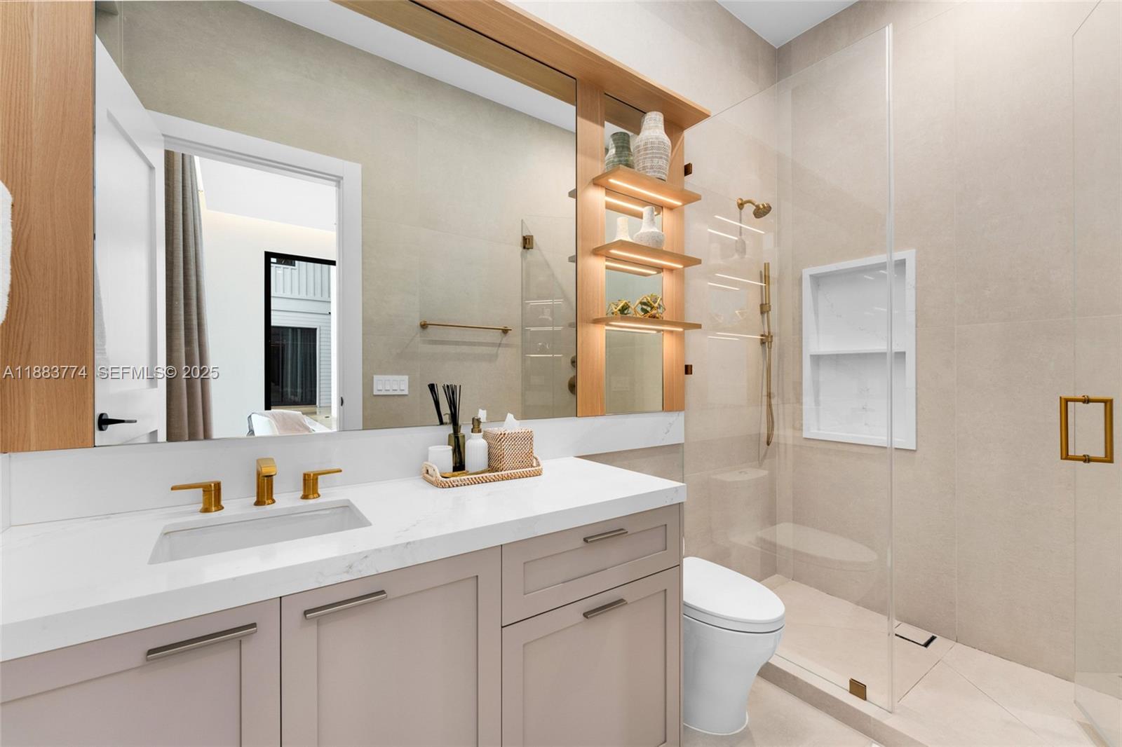 13120 Old Cutler Road Pinecrest, FL 33156 - Photo 23 of 58 a bathroom with a granite countertop sink a toilet and a mirror