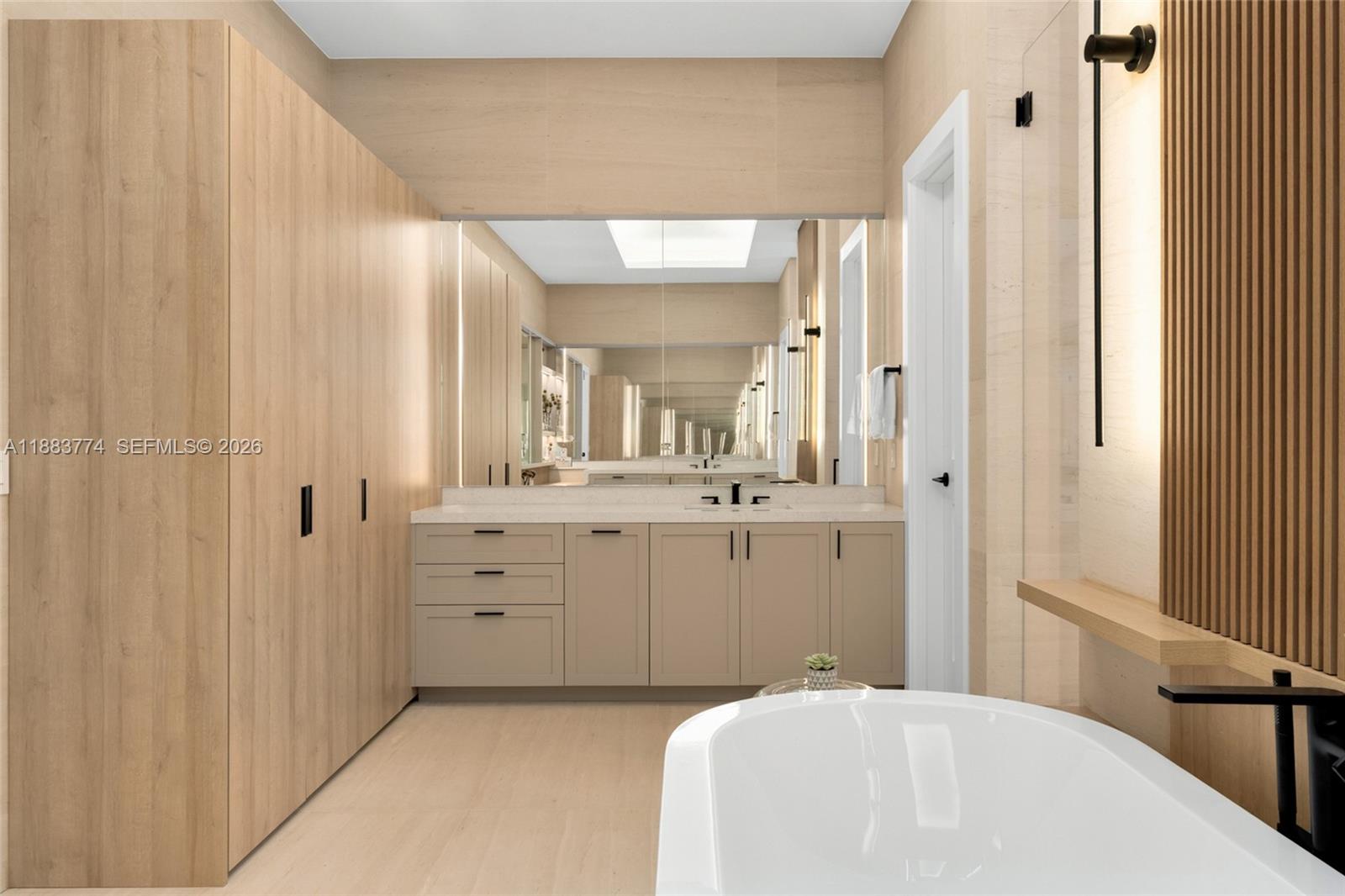 13120 Old Cutler Road Pinecrest, FL 33156 - Photo 31 of 56 a spacious bathroom with a shower a sink and a mirror