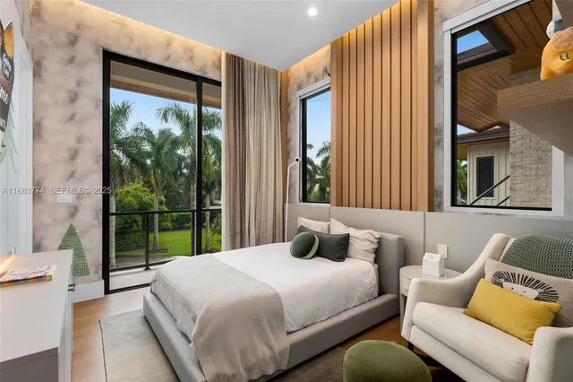 a bedroom with a bed and a large window