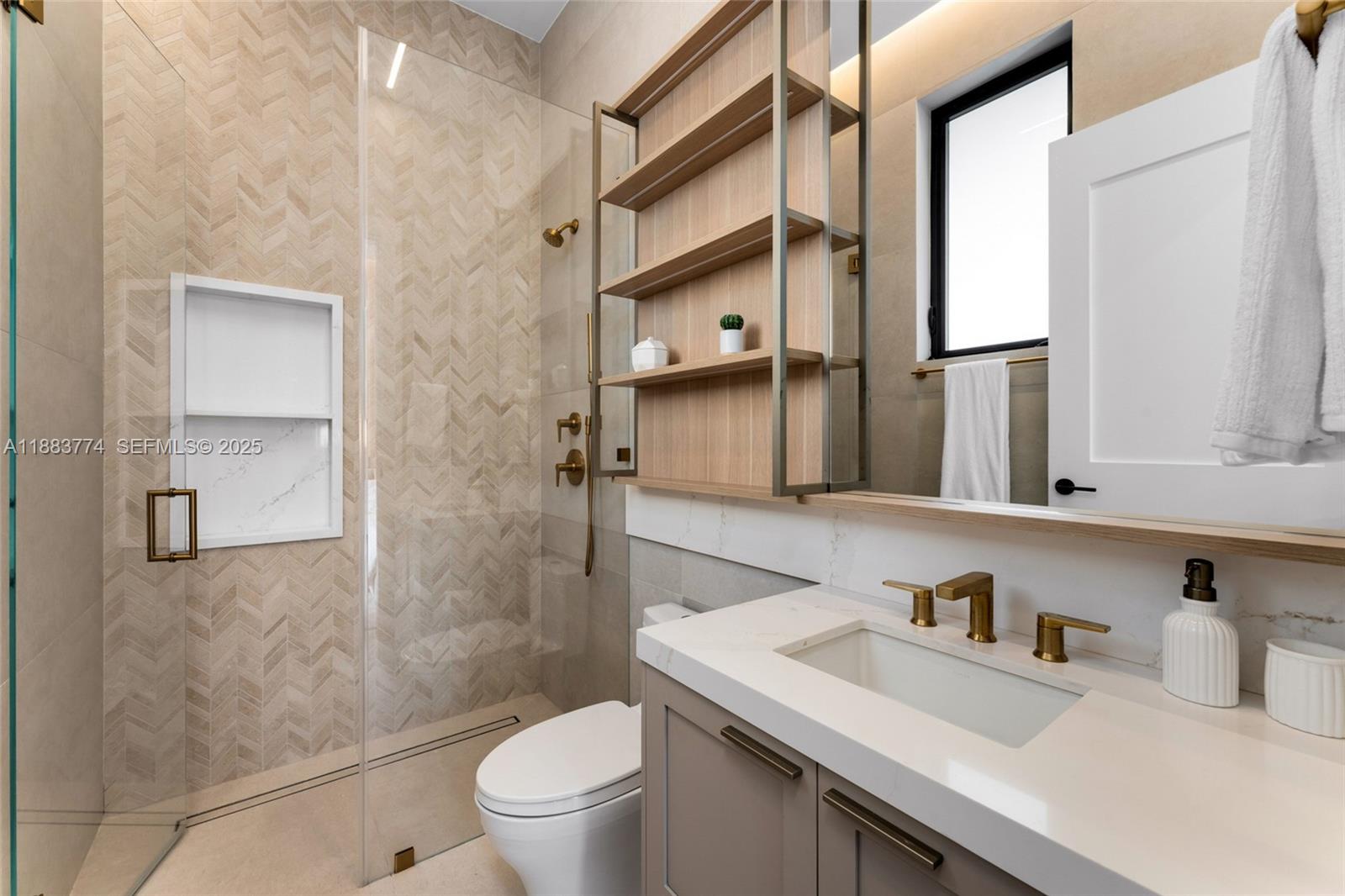 13120 Old Cutler Road Pinecrest, FL 33156 - Photo 37 of 58 a bathroom with a granite countertop sink toilet and shower