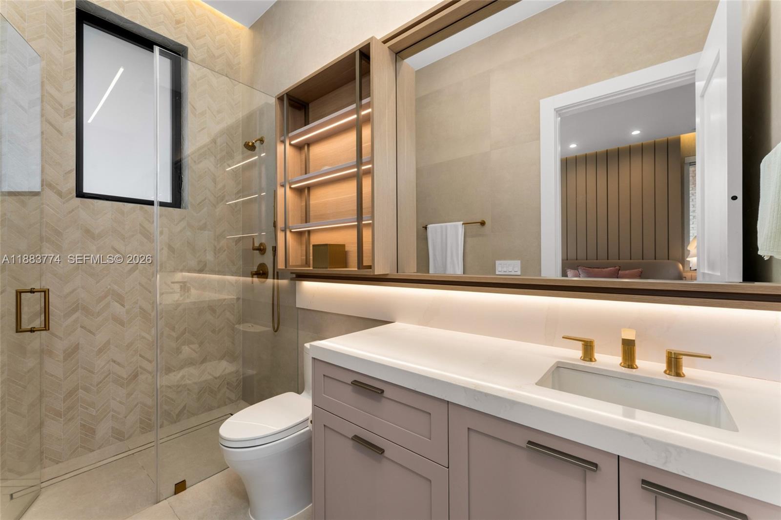 13120 Old Cutler Road Pinecrest, FL 33156 - Photo 41 of 56 a bathroom with a sink a toilet and a mirror