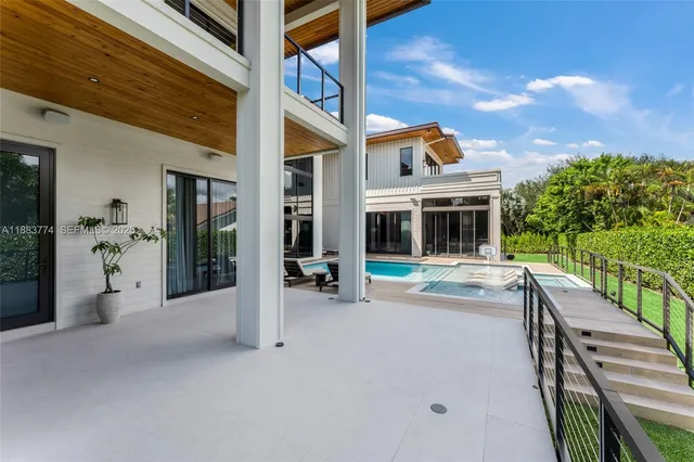 an aerial view of house with yard and outdoor seating
