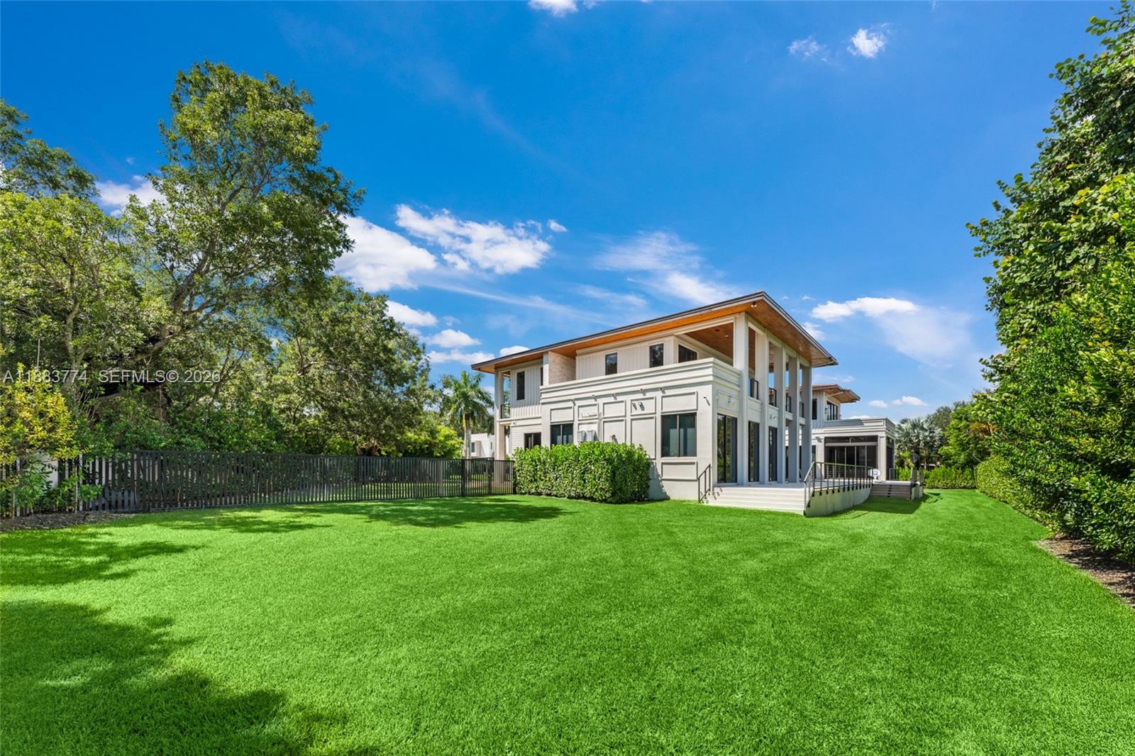 13120 Old Cutler Road Pinecrest, FL 33156 - Photo 46 of 56 a front view of a house with a yard