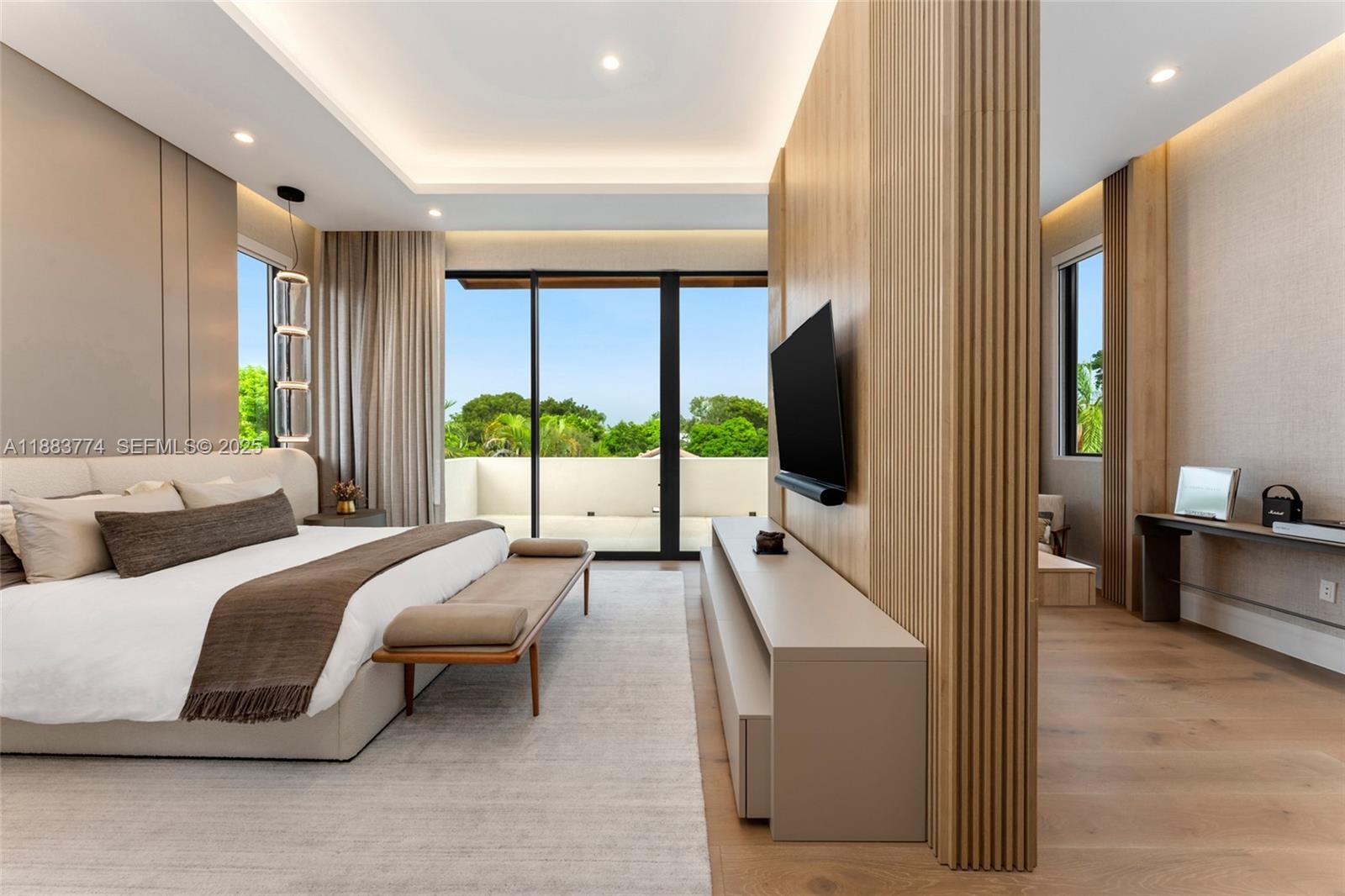 13120 Old Cutler Road Pinecrest, FL 33156 - Photo 5 of 58 a bedroom with a bed and large flat screen tv