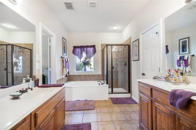 a spacious bathroom with a bathtub shower sink and mirror
