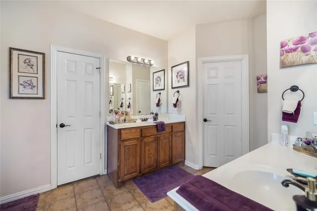 a spacious bathroom with a sink and a mirror