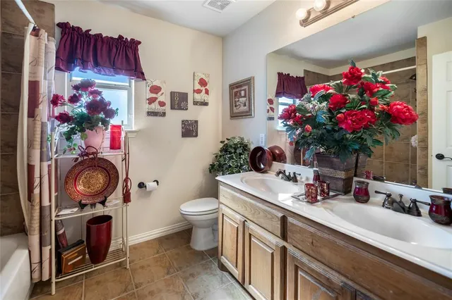 a bathroom with a sink mirror and vanity