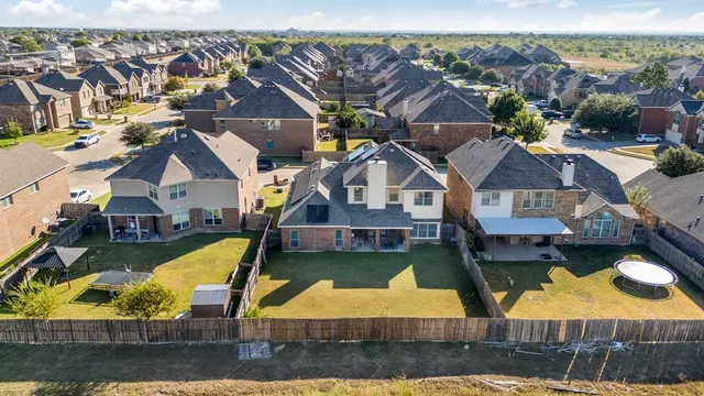 an aerial view of a house with swimming pool and ocean view