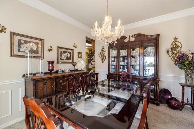 a view of a dining room with furniture and chandelier