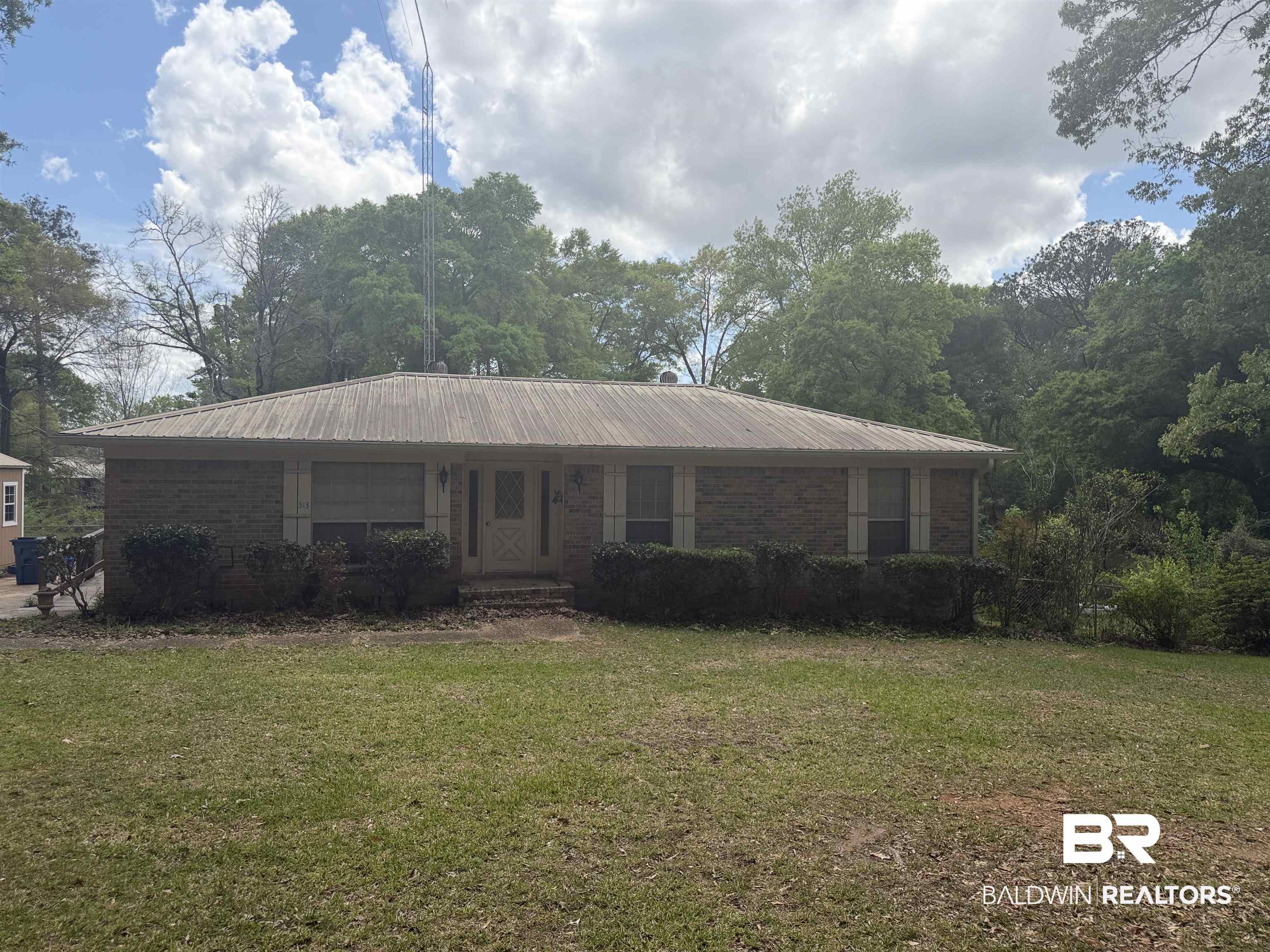 513 Club Wiley Road Jackson, AL 36545 - Photo 1 of 19 Single story home with a front yard, a metal roof, and brick siding