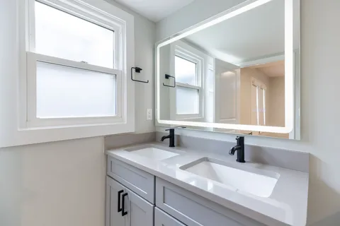 a bathroom with a sink and a window
