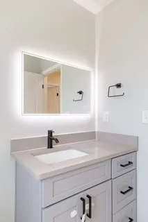 a bathroom with a sink and a mirror