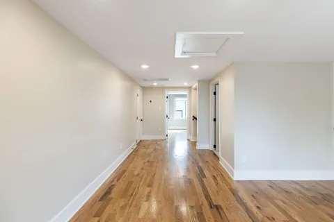 a view of a room with wooden floor