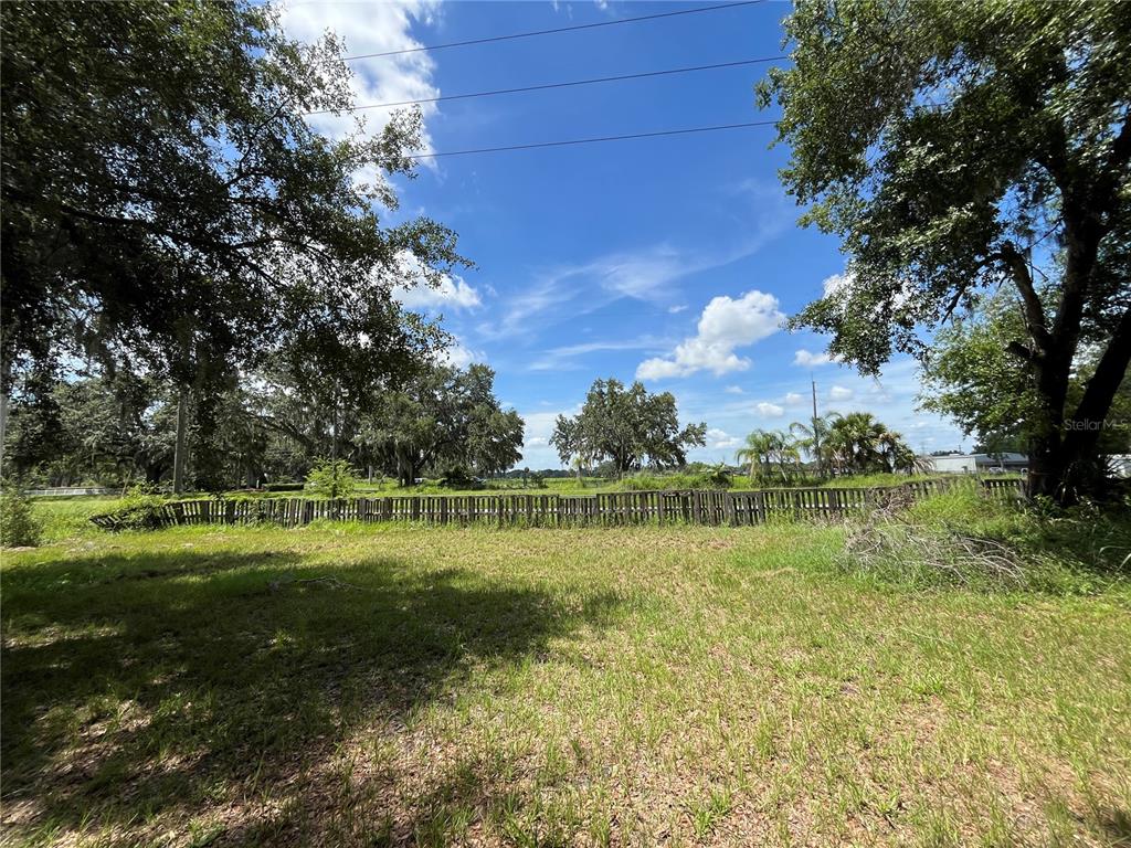 411 Alibrandi Road Leesburg, FL 34748 - Photo 13 of 44 a view of a golf course with a lake