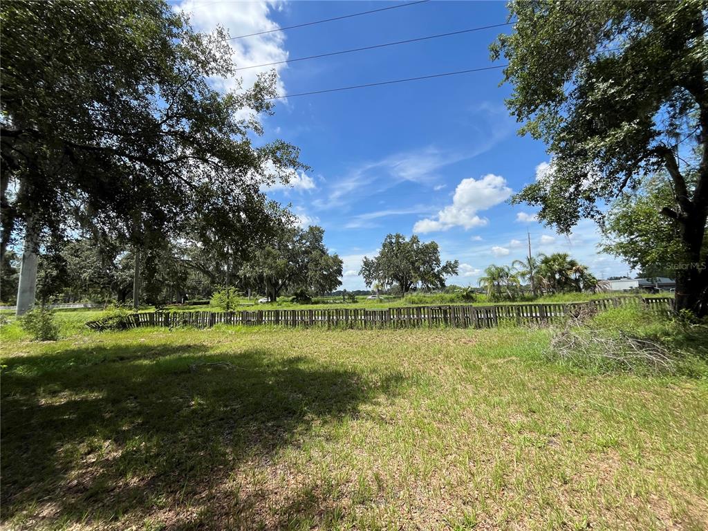 411 Alibrandi Road Leesburg, FL 34748 - Photo 14 of 44 a view of a golf course with a lake
