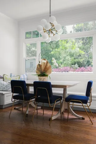 a dining room with furniture and wooden floor