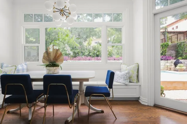 a dining room with furniture a chandelier and wooden floor