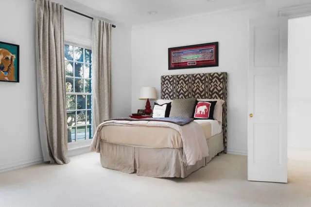 a bedroom with bed and a window