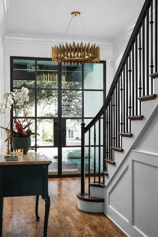 a view of entryway and hall with wooden floor