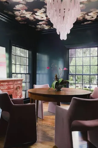 a dining room with furniture window and wooden floor