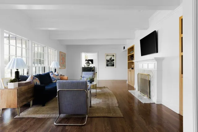 a living room with furniture a flat screen tv and a fireplace