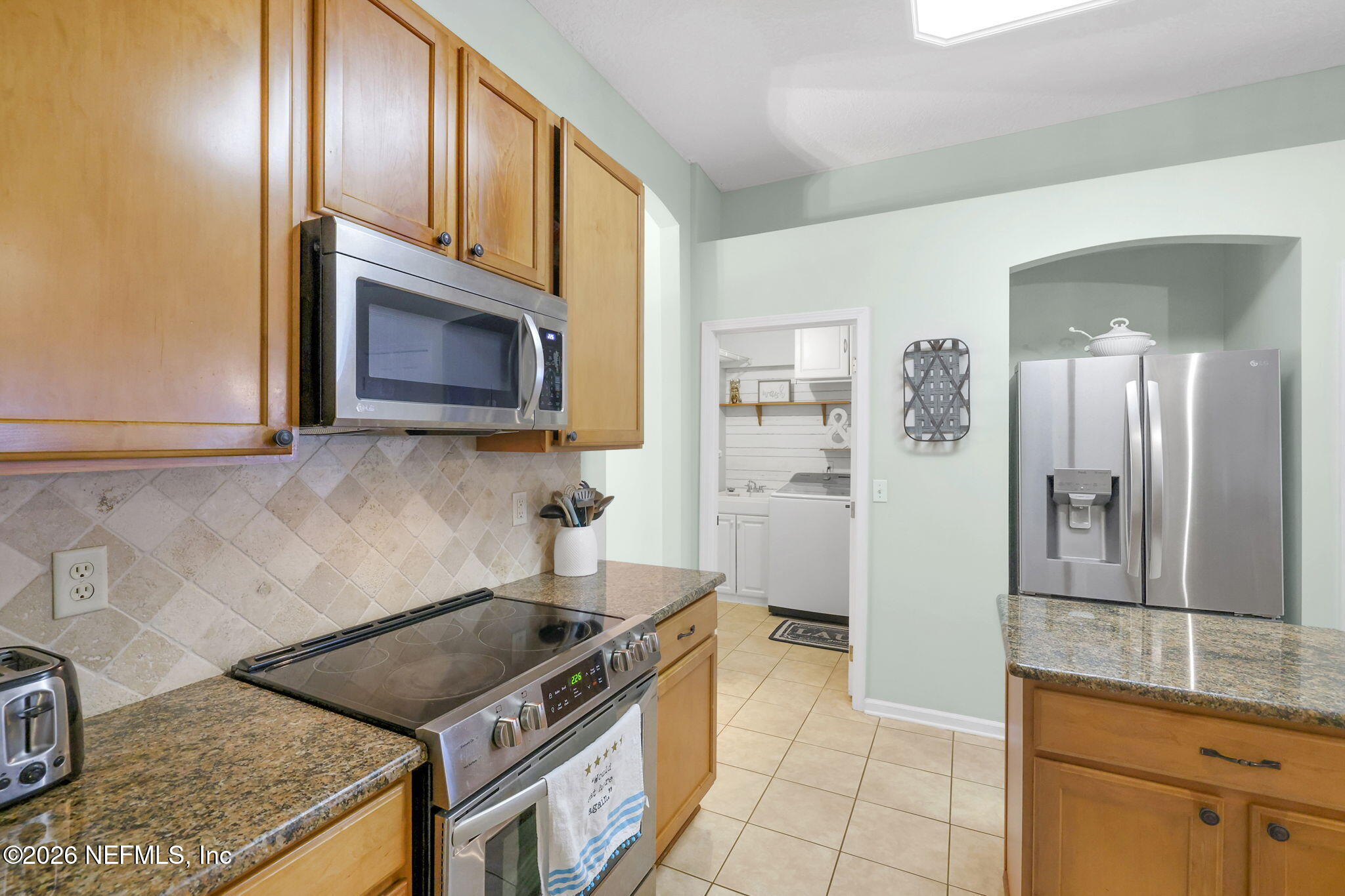 4320 Rye Court St. Johns, FL 32259 - Photo 22 of 60 a kitchen with stainless steel appliances granite countertop a stove and a microwave