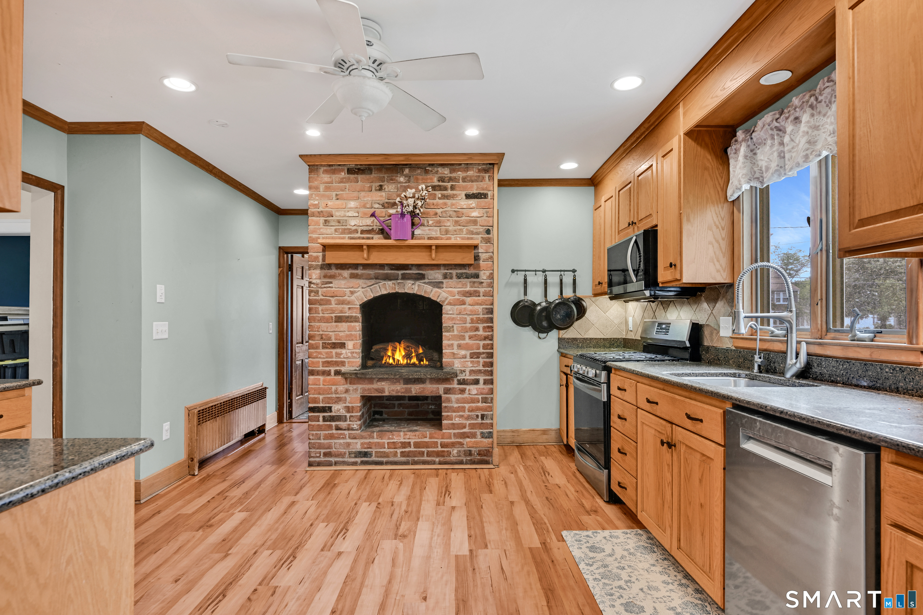 295 Wolcott Hill Road Wethersfield, CT 06109 - Photo 13 of 40 Another peek at the kitchen fireplace, hallway that leads to foyer
