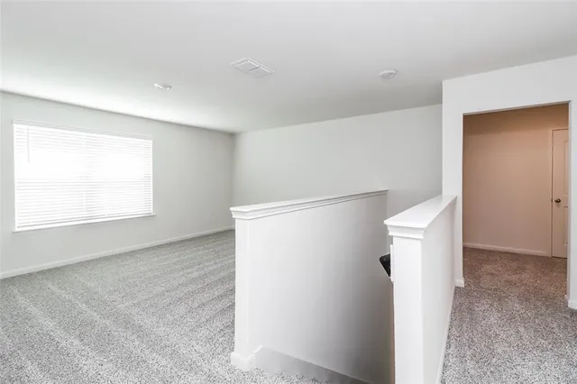 a view of an empty room with windows