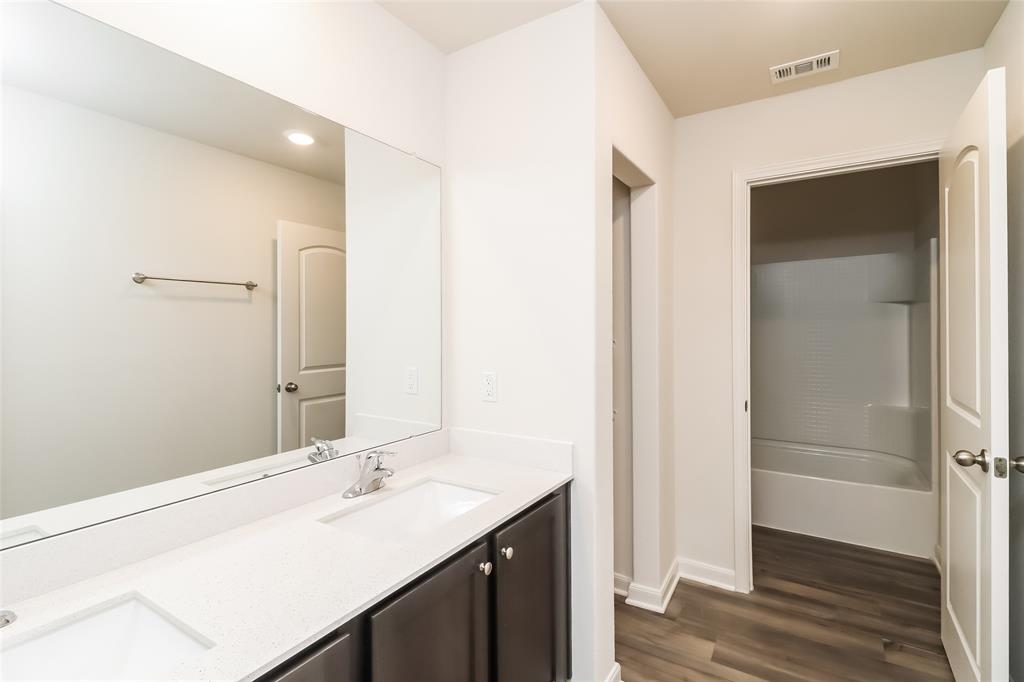 149 Switchback Hill Road Newark, TX 76071 - Photo 3 of 17 a bathroom with a sink and a mirror