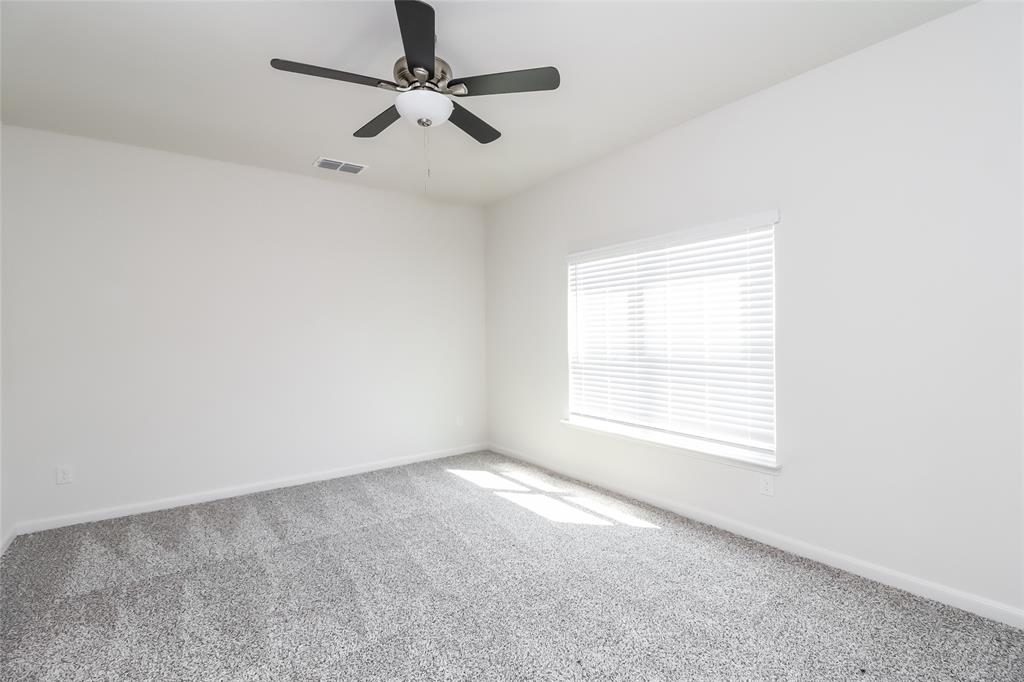 149 Switchback Hill Road Newark, TX 76071 - Photo 6 of 17 an empty room with a window and a fan
