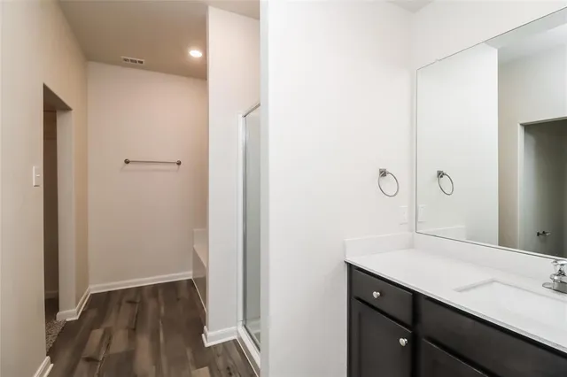 a bathroom with a sink a mirror and a shower