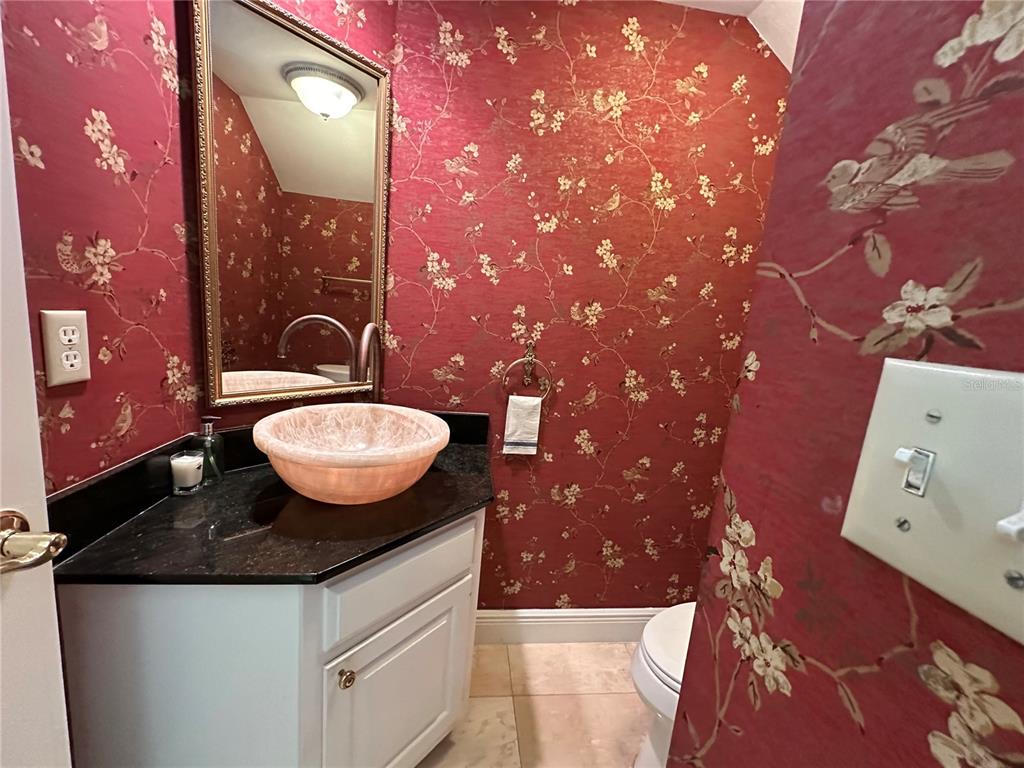 60 Bishopscourt Road, Unit 114 Osprey, FL 34229 - Photo 12 of 33 a bathroom with a sink and a mirror