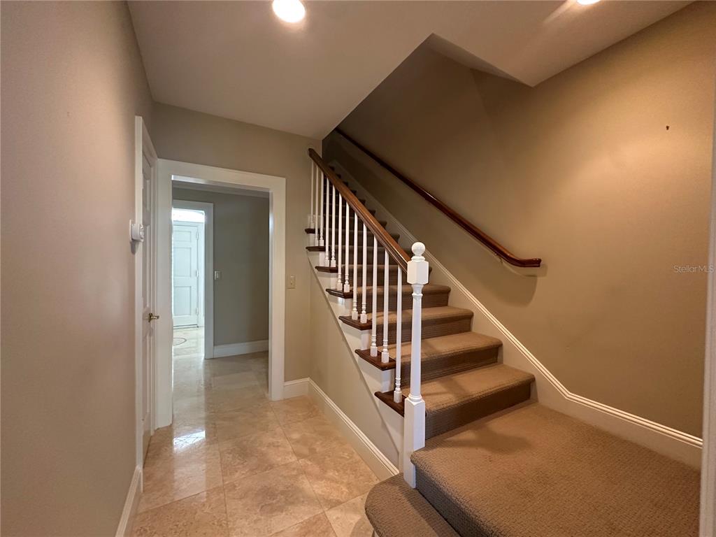 60 Bishopscourt Road, Unit 114 Osprey, FL 34229 - Photo 14 of 33 a view of entryway and hall with wooden floor