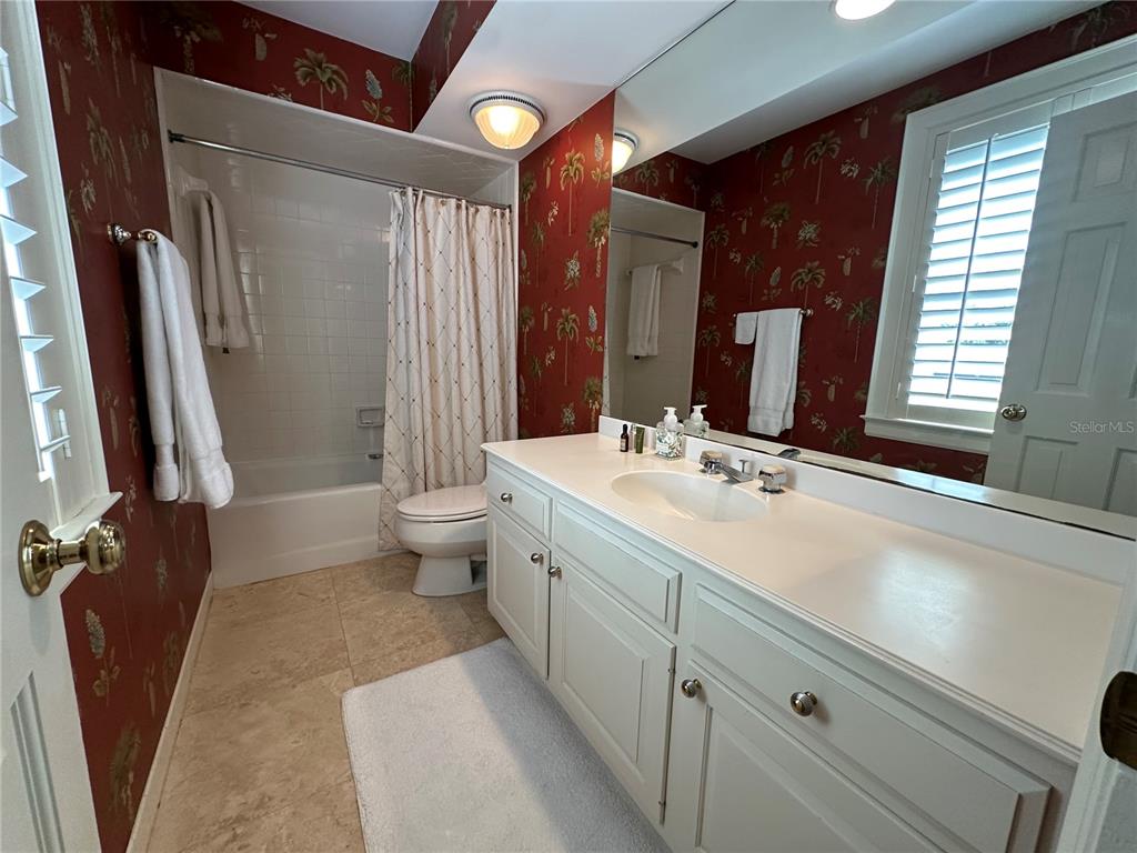 60 Bishopscourt Road, Unit 114 Osprey, FL 34229 - Photo 15 of 33 a bathroom with a double vanity sink toilet and shower