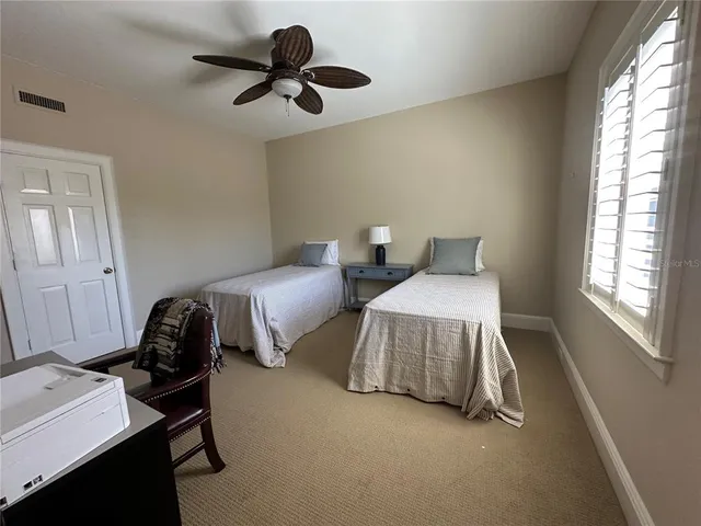 a bedroom with bed and a window