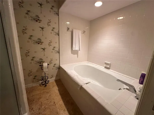 a bathroom with a bathtub and a shower