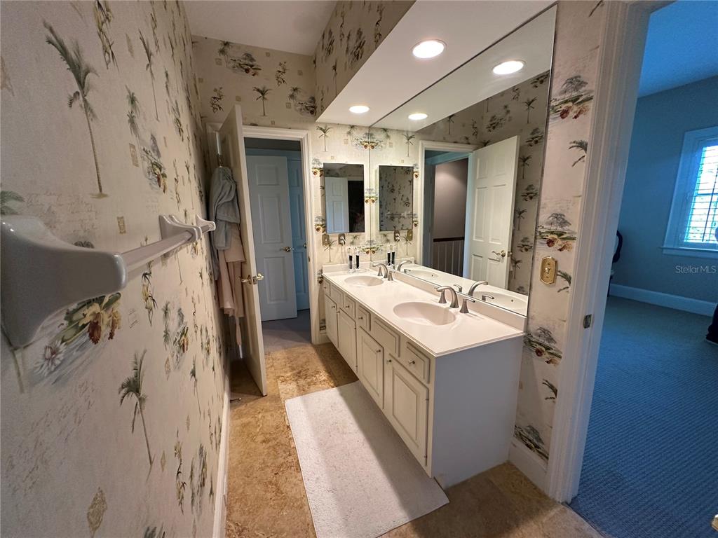 60 Bishopscourt Road, Unit 114 Osprey, FL 34229 - Photo 22 of 33 a bathroom with a double vanity sink mirror and shower