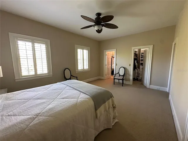 a bed room with a bed and a chandelier