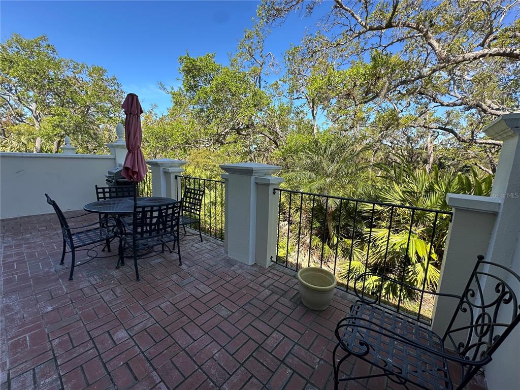 60 Bishopscourt Road, Unit 114 Osprey, FL 34229 - Photo 27 of 33 a view of a chairs and table in the patio