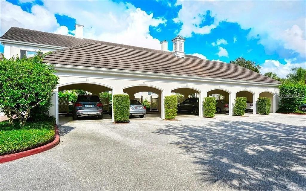 60 Bishopscourt Road, Unit 114 Osprey, FL 34229 - Photo 28 of 33 a view of a house with potted plants