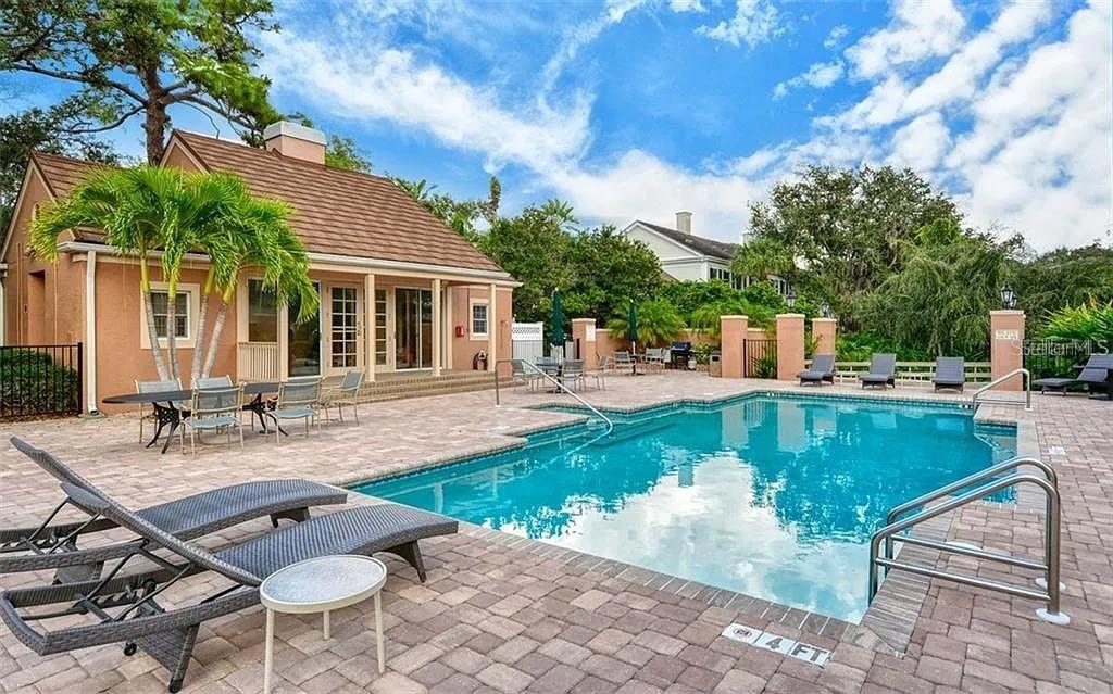 60 Bishopscourt Road, Unit 114 Osprey, FL 34229 - Photo 30 of 33 a view of a house with backyard porch and sitting area